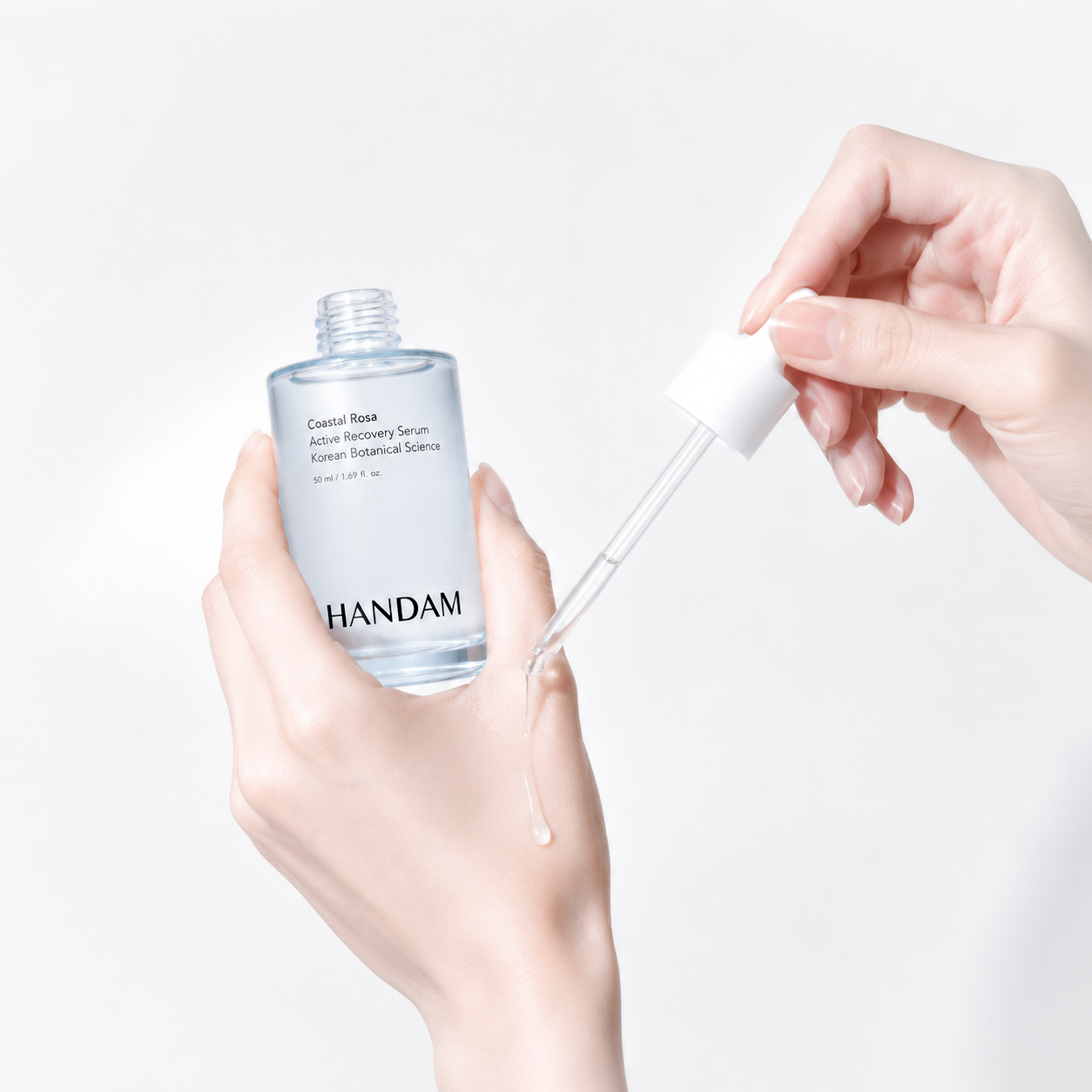 Holding the Coastal Rosa serum with dropper